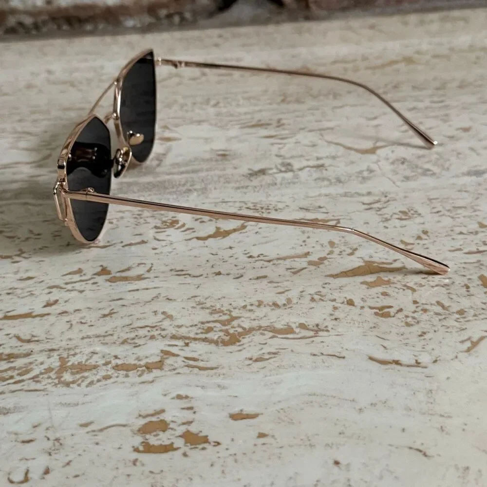Rose gold wire frame cat eye aviator sunglasses with reflective pink lenses.